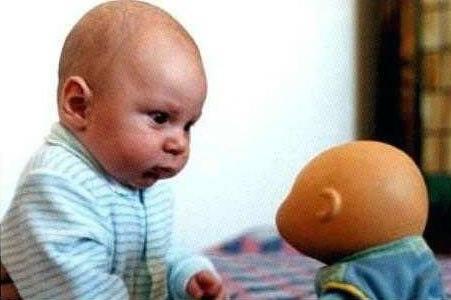 Foto Divertente: Bambino che guarda in cagnesco bambolotto