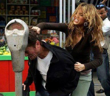 Foto Divertente: Donna che sbatte la testa di un uomo contro parchimetro